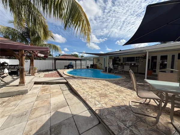 a view of a swimming pool with a patio