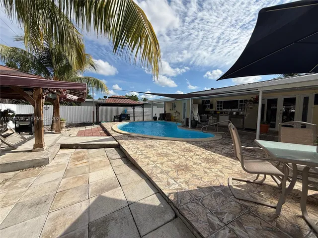 a view of a swimming pool with a patio