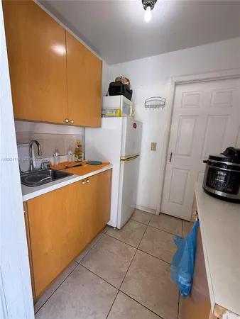 a utility room with sink dryer and washer