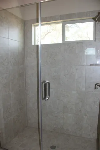 a bathroom with a shower and a window
