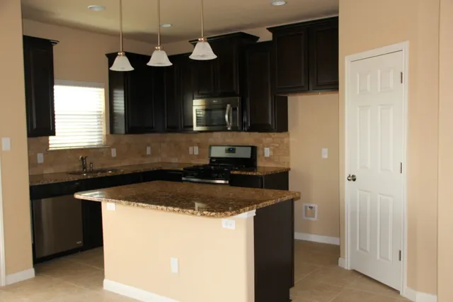 a kitchen with a sink and a refrigerator
