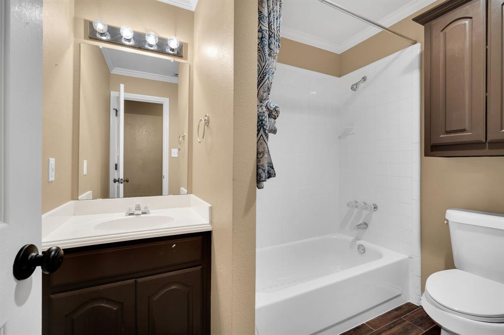 1907 Timber Ridge Court Cedar Hill, TX 75104 - Photo 21 of 30 Full bathroom featuring a single vanity with a dark wood-finish cabinet, white countertop, and chrome faucet