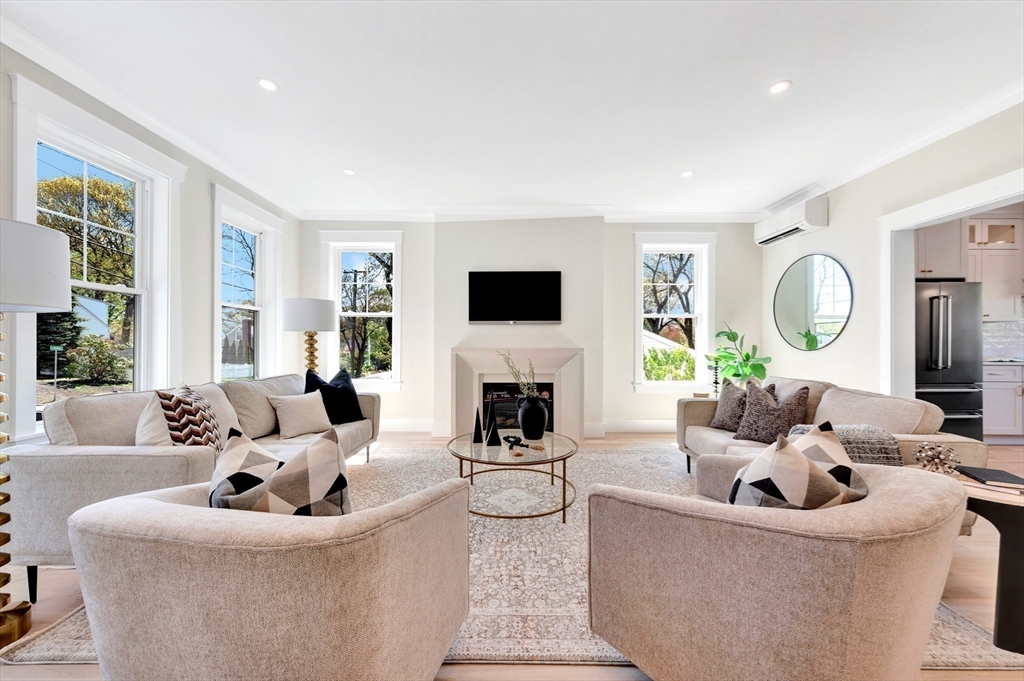 354 Ridge Street Arlington, MA 02474 - Photo 15 of 42 a living room with fireplace furniture and a large window