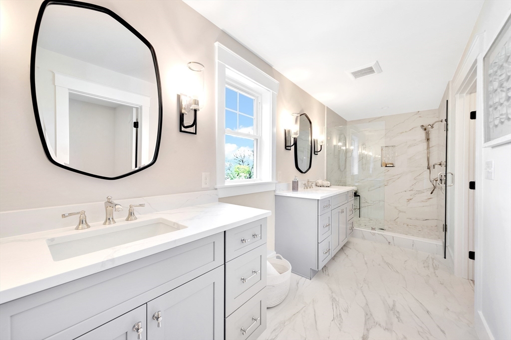 354 Ridge Street Arlington, MA 02474 - Photo 27 of 42 a en suite bathroom with a double vanity sink and a mirror