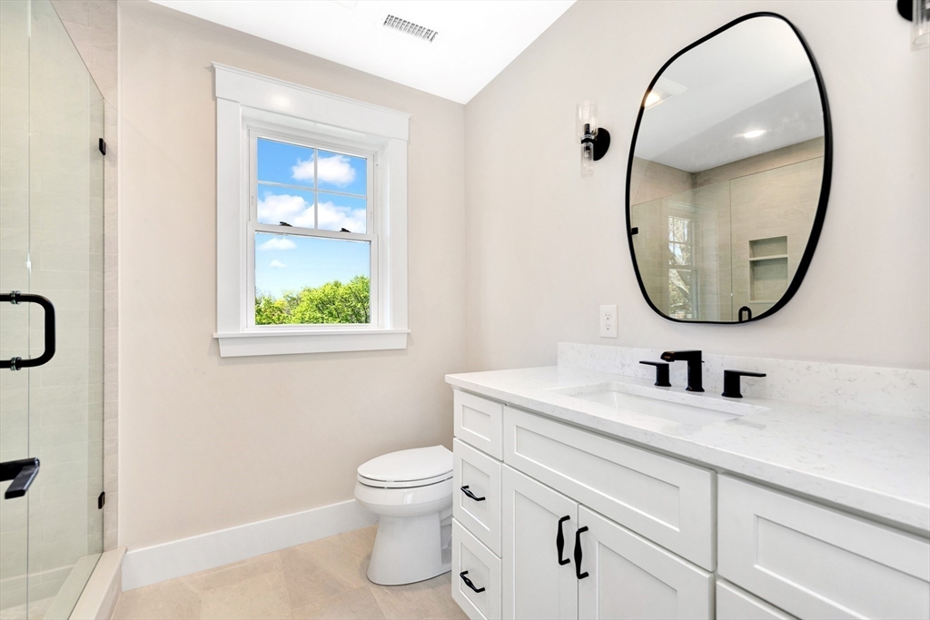 354 Ridge Street Arlington, MA 02474 - Photo 31 of 42 a bathroom with a sink a toilet and a mirror