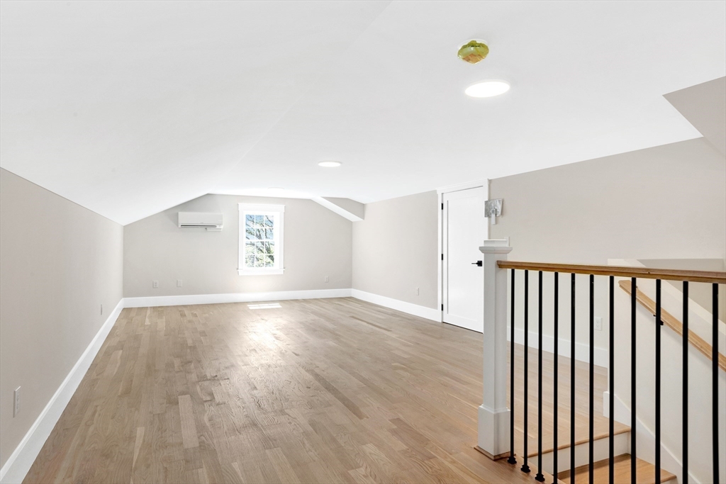 354 Ridge Street Arlington, MA 02474 - Photo 32 of 42 a view of an empty room with wooden floor