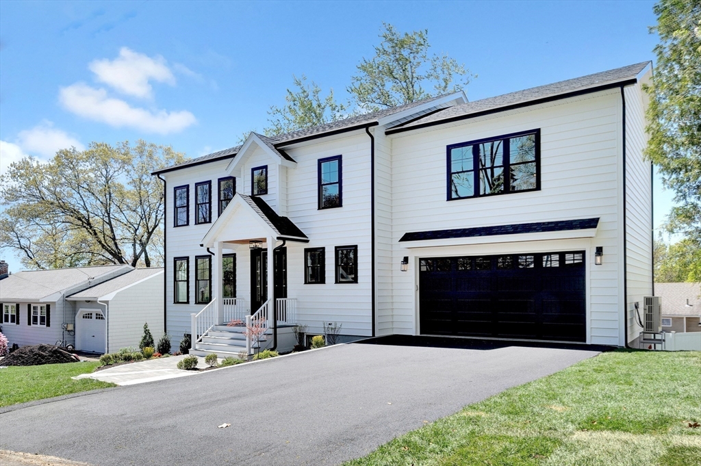 354 Ridge Street Arlington, MA 02474 - Photo 40 of 42 a front view of a house with a yard and garage