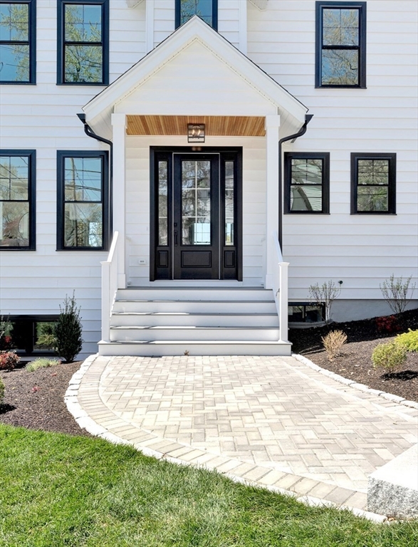 354 Ridge Street Arlington, MA 02474 - Photo 41 of 42 a front view of a house with a yard