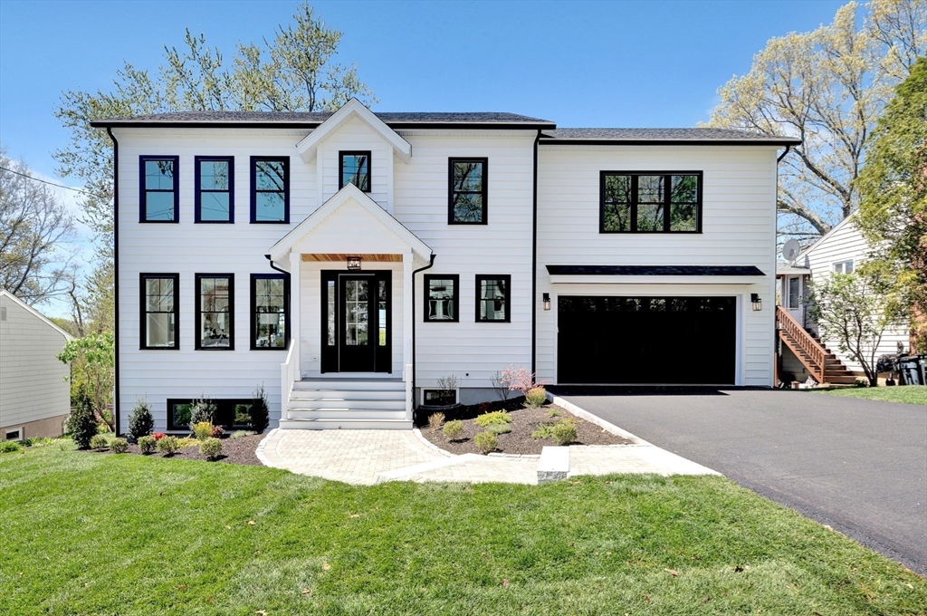 354 Ridge Street Arlington, MA 02474 - Photo 42 of 42 a front view of a house with a yard and garage