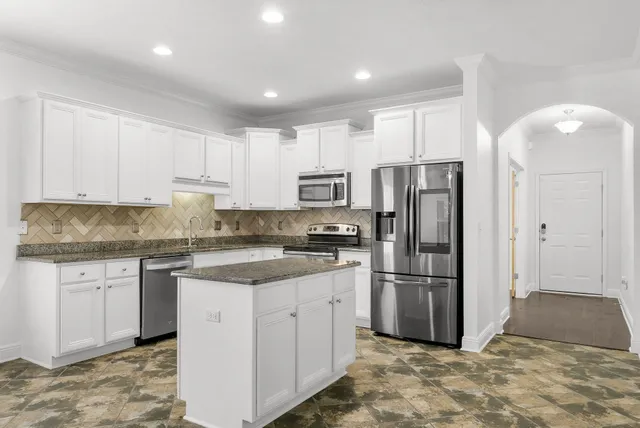 a kitchen with a refrigerator a sink and dishwasher