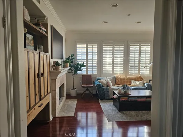 a living room with furniture fireplace and large windows