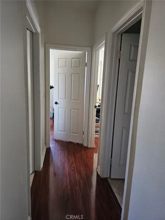 a view of a hallway with wooden floor