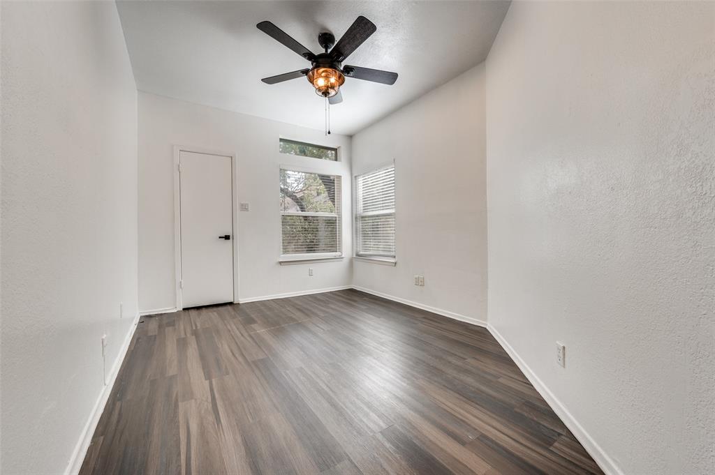 5550 Spring Valley Road, Unit E22 Dallas, TX 75254 - Photo 3 of 14 an empty room with wooden floor and windows