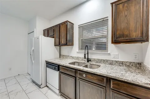 a kitchen with a sink cabinets and window