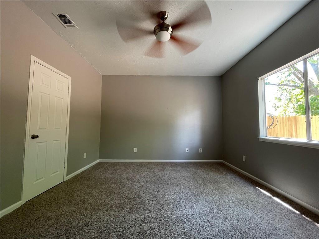 2114 Zephyr Lane Round Rock, TX 78664 - Photo 13 of 27 an empty room with windows and ceiling fan