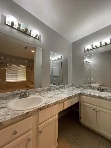 a bathroom with a sink double vanity and a mirror