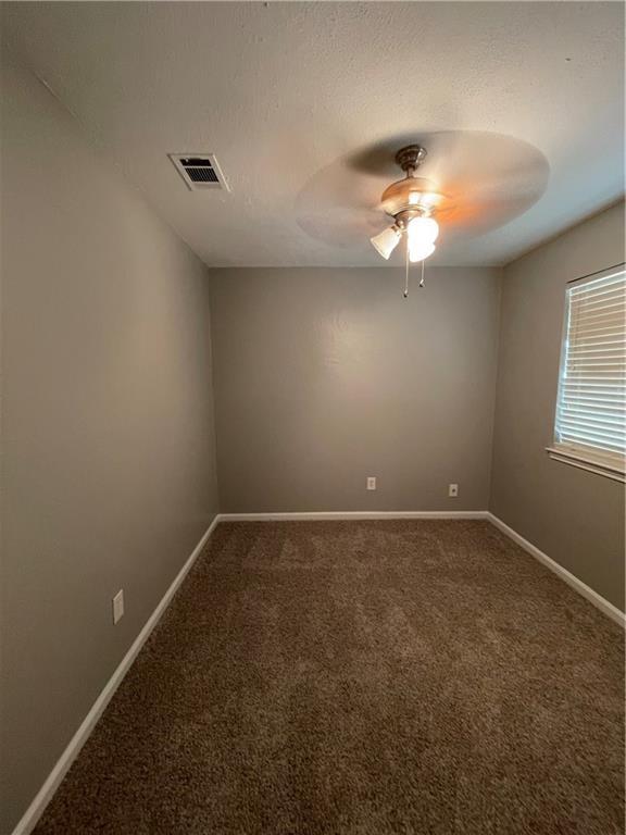 2114 Zephyr Lane Round Rock, TX 78664 - Photo 19 of 27 an empty room with a window and a ceiling fan