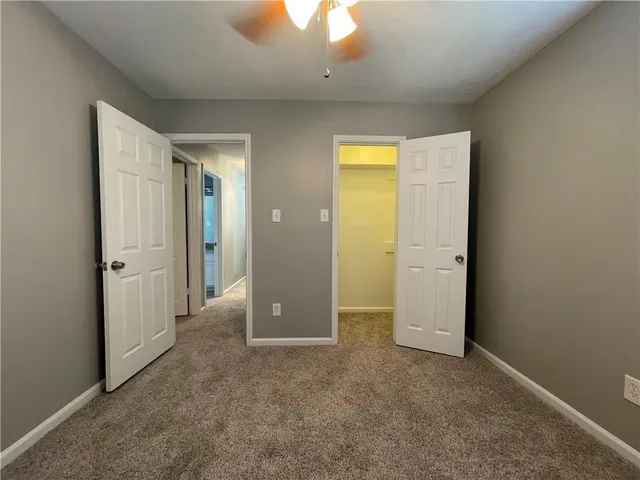 an empty room with closet and a bathroom