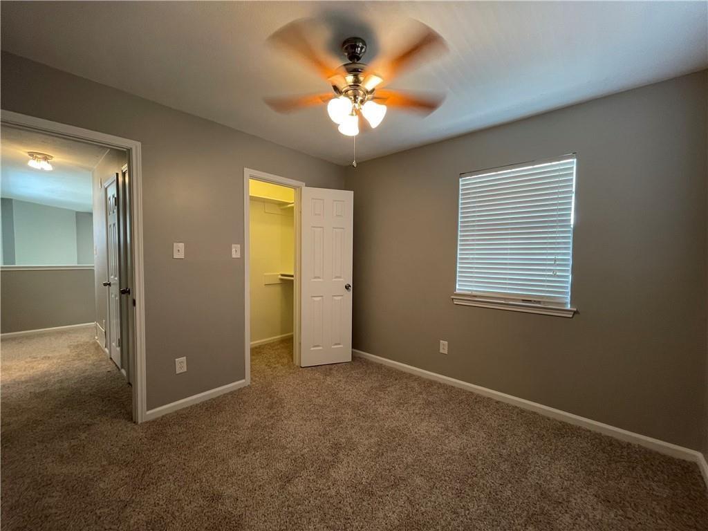 2114 Zephyr Lane Round Rock, TX 78664 - Photo 23 of 27 an empty room with a chandelier fan and windows