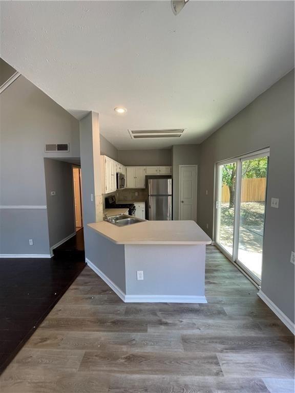 2114 Zephyr Lane Round Rock, TX 78664 - Photo 8 of 27 a living room with stainless steel appliances kitchen island a large counter top and a wooden floor