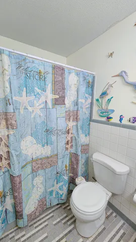 a white toilet sitting next to a bathroom sink
