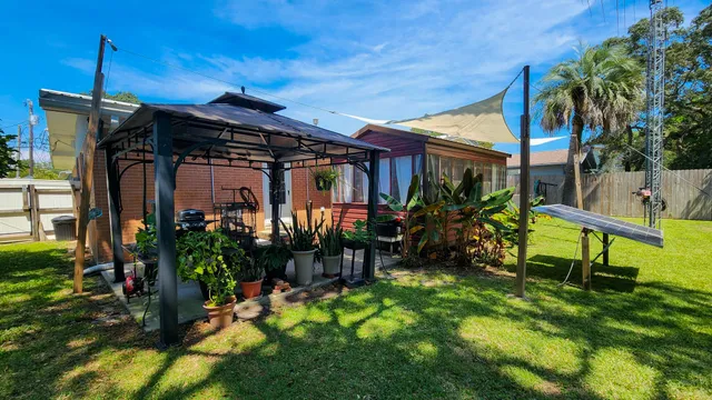 a view of a chair and table in backyard