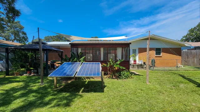 a view of a house with a yard patio and fire pit