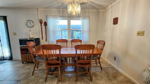 a view of a dining room with furniture and window