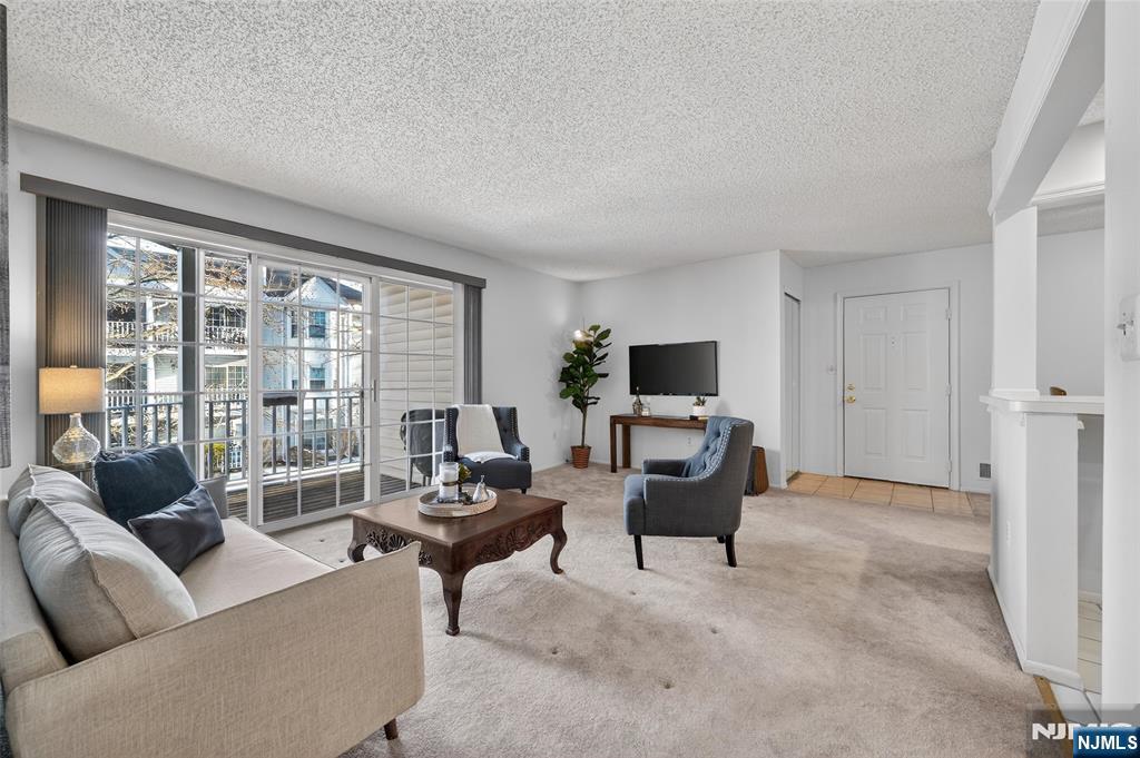 560 Holly Court Mahwah, NJ 07430 - Photo 15 of 33 a living room with furniture and a flat screen tv