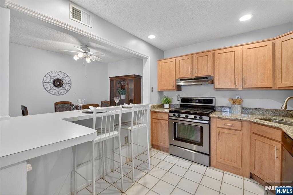 560 Holly Court Mahwah, NJ 07430 - Photo 16 of 33 a kitchen with a stove a sink and a refrigerator