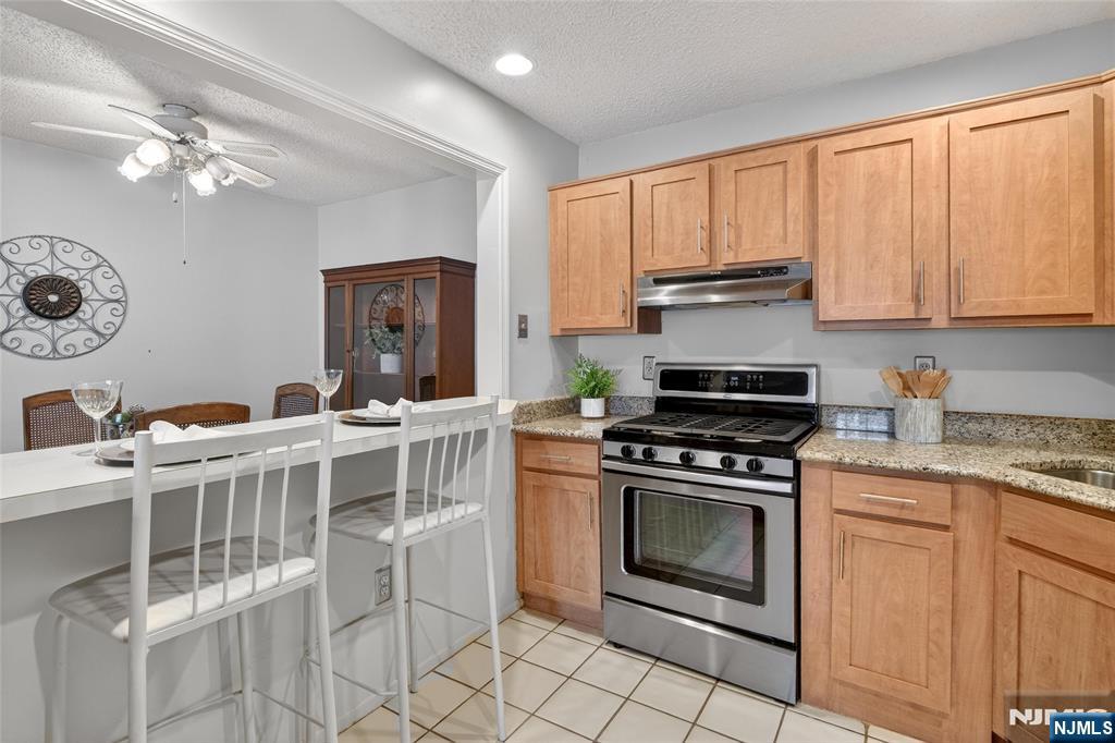 560 Holly Court Mahwah, NJ 07430 - Photo 17 of 33 a kitchen with a stove top oven cabinets and a window