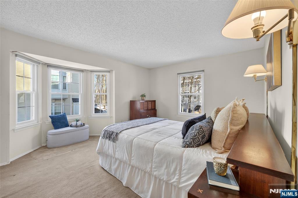 560 Holly Court Mahwah, NJ 07430 - Photo 21 of 33 a bedroom with a bed flat screen tv and window