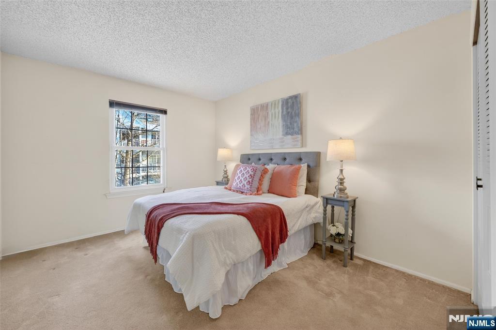 560 Holly Court Mahwah, NJ 07430 - Photo 26 of 33 a bedroom with a bed and a window