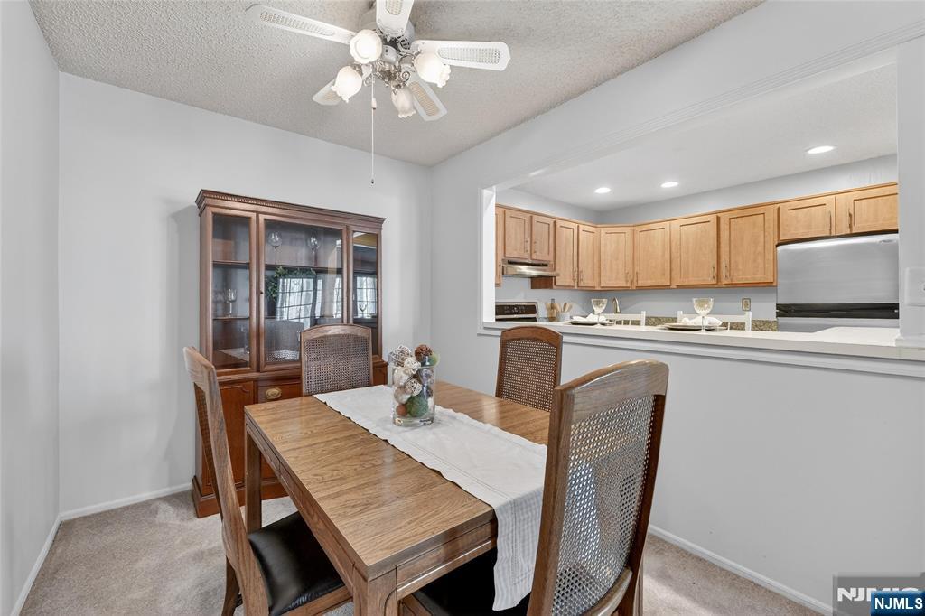 560 Holly Court Mahwah, NJ 07430 - Photo 5 of 33 a kitchen with a dining table chairs and refrigerator