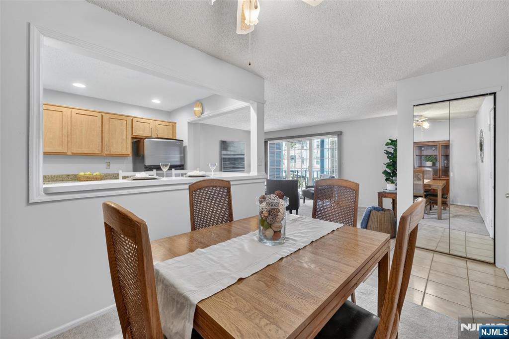 560 Holly Court Mahwah, NJ 07430 - Photo 6 of 33 a kitchen with kitchen island a dining table chairs and white appliances