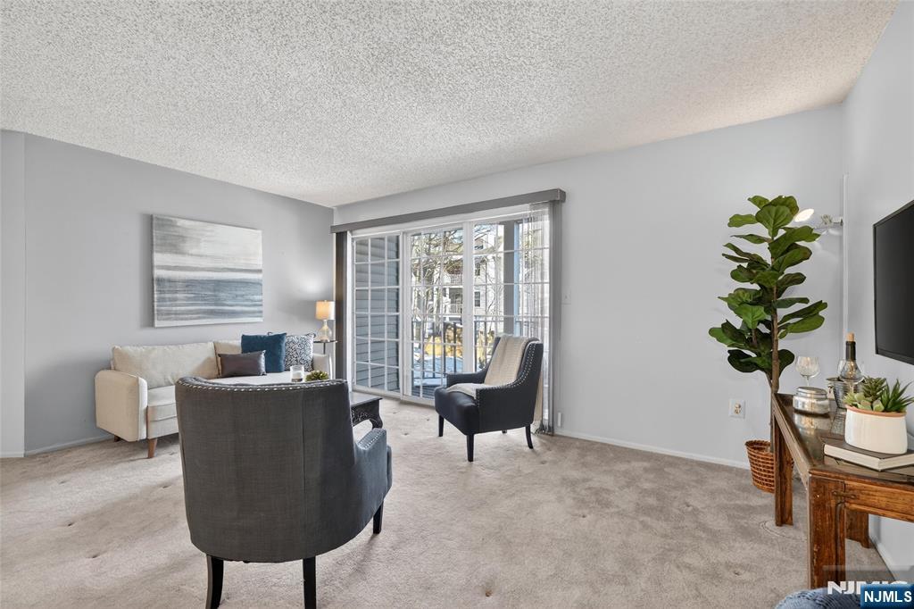 560 Holly Court Mahwah, NJ 07430 - Photo 8 of 33 a living room with furniture and a potted plant