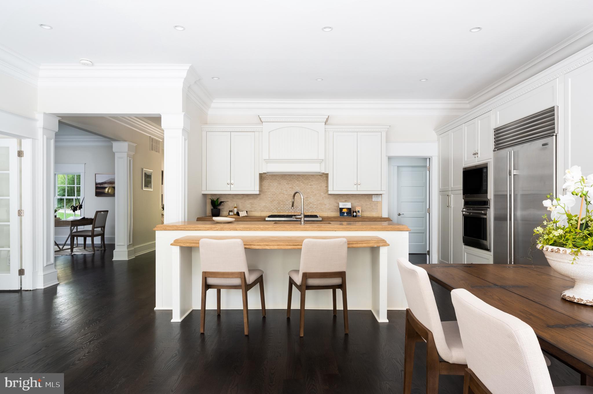 2913 University Terrace Northwest Washington, DC 20016 - Photo 12 of 46 a kitchen with a dining table chairs and refrigerator