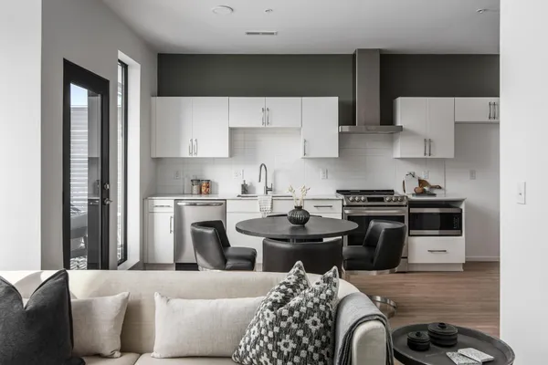 a kitchen with stainless steel appliances a stove a sink and a refrigerator