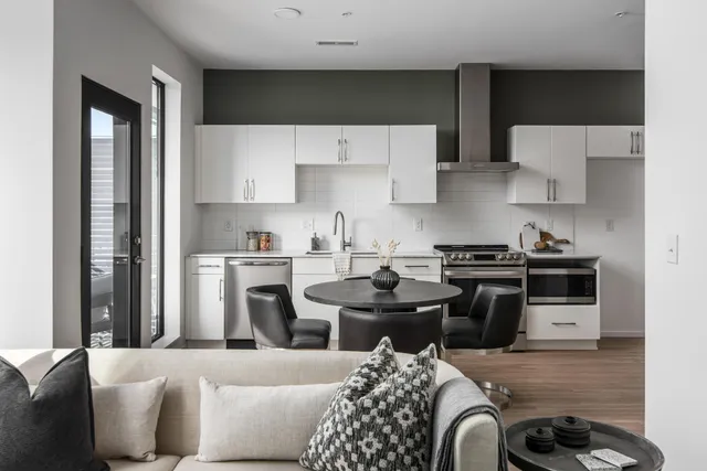 a kitchen with stainless steel appliances a stove a sink and a refrigerator