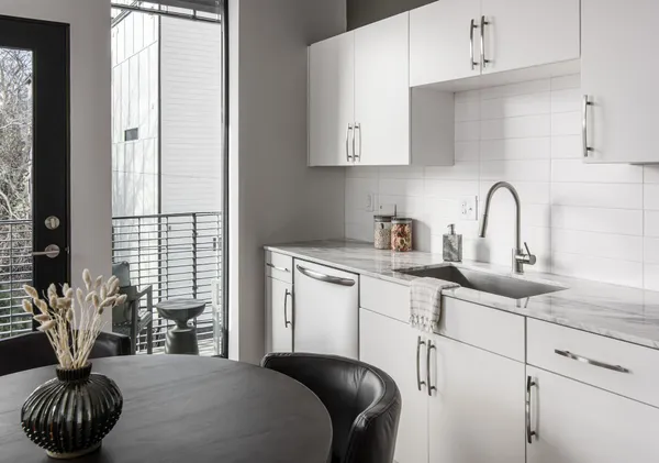 a kitchen with a table and chairs