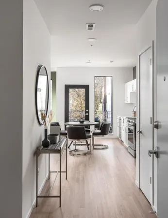 a kitchen with stainless steel appliances a dining table and chairs