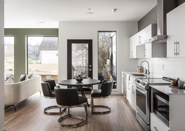 a dining room with furniture and wooden floor