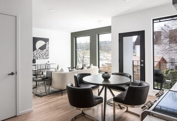 a living room with furniture and a mirror