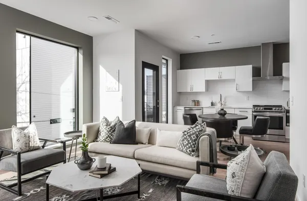 a view of a dining room with furniture and a potted plant