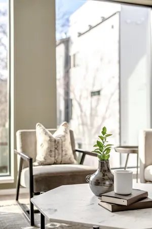 a kitchen with stainless steel appliances kitchen island granite countertop a sink a stove a refrigerator and white cabinets