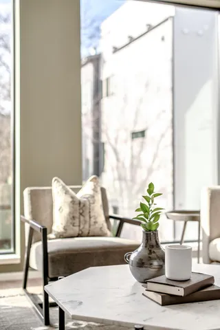 a kitchen with stainless steel appliances kitchen island granite countertop a sink a stove a refrigerator and white cabinets