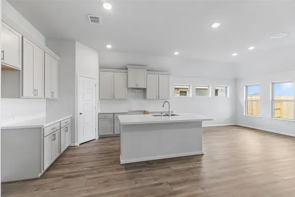 a kitchen that has a sink and a stove in it