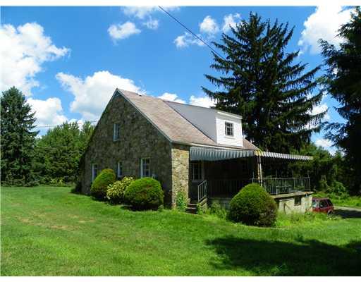 772 Highway 31 Ruffs Dale, PA 15679 - Photo 15 of 18 Exterior Back. The rear covered patio is located above the 1-car garage.