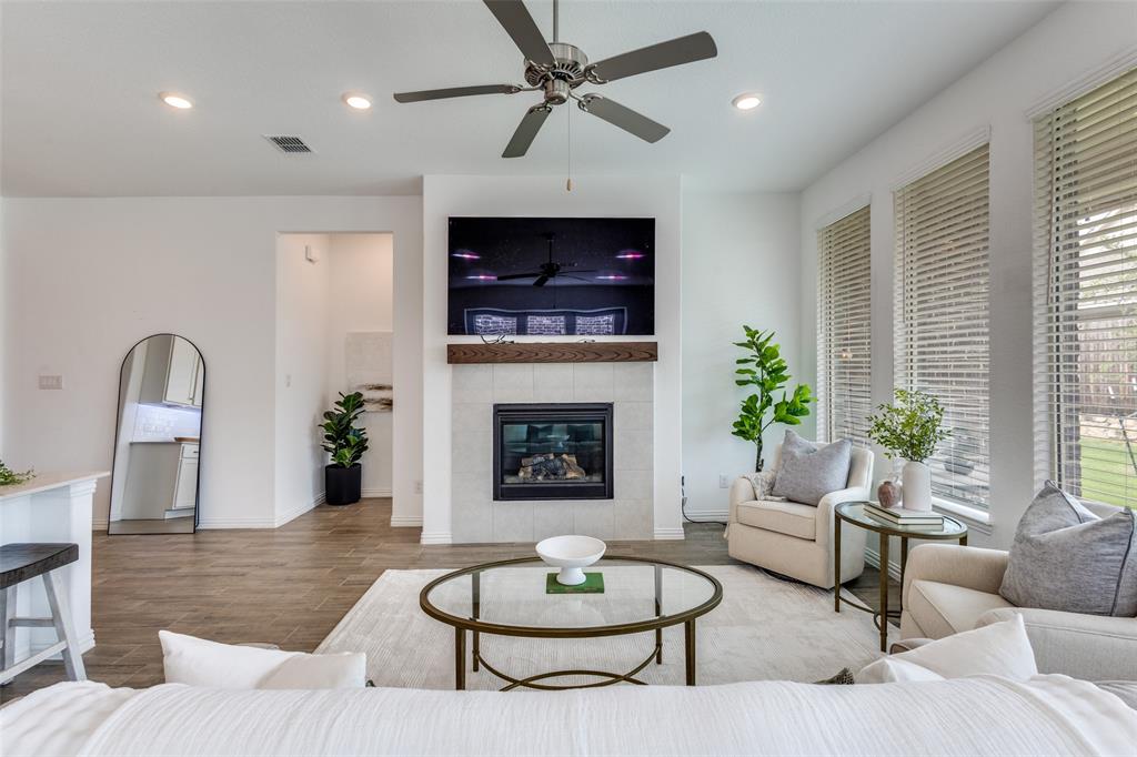 307 Red Cedar Drive Princeton, TX 75407 - Photo 7 of 26 Living room featuring recessed lighting, a tile fireplace, wood finished floors, and ceiling fan
