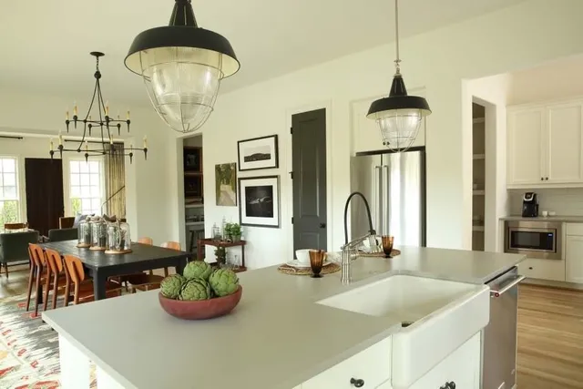a kitchen with granite countertop white cabinets and stainless steel appliances